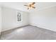 Cozy bedroom with neutral walls, plush carpet, a ceiling fan, and a window at 903 W 22Nd St, Anderson, IN 46016
