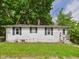 Charming single-story home with classic white siding, black shutters, and well-maintained front lawn at 903 W 22Nd St, Anderson, IN 46016