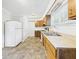 Functional kitchen with wooden cabinets, white appliances, and tile flooring at 903 W 22Nd St, Anderson, IN 46016