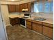 Kitchen showcasing wooden cabinets, white appliances, and lots of countertop space at 903 W 22Nd St, Anderson, IN 46016