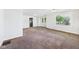 Bright living room with a decorative brick wall, plush carpet, and ample natural light at 903 W 22Nd St, Anderson, IN 46016