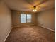 Spacious bedroom with carpet and natural light, offering a serene retreat, and ceiling fan at 9145 Blue Pine Dr, Indianapolis, IN 46231