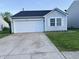 Charming single-story home featuring a one-car garage, light blue siding and a well-maintained lawn at 9145 Blue Pine Dr, Indianapolis, IN 46231