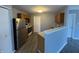 Functional kitchen features wood cabinets, stainless-steel refrigerator, and a breakfast bar at 9145 Blue Pine Dr, Indianapolis, IN 46231