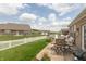A inviting patio with a view of the community lawn and white picket fence at 9166 Lieven St, Avon, IN 46123