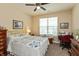 Cozy bedroom features neutral walls, a large window, and a quaint sewing station at 9166 Lieven St, Avon, IN 46123