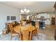 Bright dining area with wood table and chairs leads into the kitchen and living room at 9166 Lieven St, Avon, IN 46123