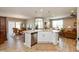 The kitchen island features stainless steel dishwasher and a sink with views into the living and dining area at 9166 Lieven St, Avon, IN 46123