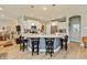 Open kitchen boasts a large island with seating, granite countertops, and stainless steel appliances at 9166 Lieven St, Avon, IN 46123