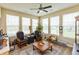 Sunny living room includes a ceiling fan, many large windows, and comfortable seating at 9166 Lieven St, Avon, IN 46123