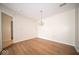 Dining room features modern lighting and wood floors adjacent to doorway at 931 Wickham Ct # 101, Carmel, IN 46032