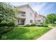 Apartment exterior with a balcony, a sliding glass door, and verdant landscaping at 931 Wickham Ct # 101, Carmel, IN 46032