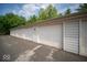 Exterior view of a well-maintained garage with white doors and siding, offering secure parking at 931 Wickham Ct # 101, Carmel, IN 46032