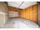 Inside the garage, displaying wood paneling, bare drywall, and a concrete floor, awaiting customization at 931 Wickham Ct # 101, Carmel, IN 46032