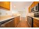 Efficient kitchen layout with stainless appliances and wood flooring at 931 Wickham Ct # 101, Carmel, IN 46032