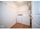 Functional laundry room with washer, dryer, and laminate flooring at 931 Wickham Ct # 101, Carmel, IN 46032