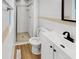 Bathroom featuring vinyl floors, toilet, vanity, and a tiled walk-in shower at 9490 E 36Th Pl, Indianapolis, IN 46235