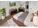 Cozy bedroom with natural light features neutral colors, hardwood furnishings, closet, and a plush area rug at 9490 E 36Th Pl, Indianapolis, IN 46235
