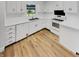 Well-lit kitchen with white cabinets, stainless steel appliances, and hardwood floors at 9490 E 36Th Pl, Indianapolis, IN 46235