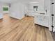 Bright kitchen features white cabinets, modern countertops, and luxury vinyl plank flooring at 9490 E 36Th Pl, Indianapolis, IN 46235