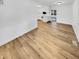 Open-concept room with hardwood floors, white cabinets and an open layout to the kitchen at 9490 E 36Th Pl, Indianapolis, IN 46235