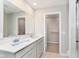 Modern bathroom featuring double sinks, spacious countertop, and a walk-in closet at 9570 Beckett St, Avon, IN 46123