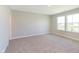 Bright bedroom featuring carpeted floors and double windows overlooking a tranquil view at 9570 Beckett St, Avon, IN 46123