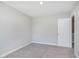Simple bedroom with neutral paint and carpet featuring an open door at 9570 Beckett St, Avon, IN 46123