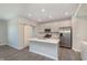 Well-lit kitchen featuring stainless steel appliances, a center island, and sleek countertops at 9570 Beckett St, Avon, IN 46123