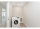 Well-lit laundry room with tile floors featuring a washing machine at 9570 Beckett St, Avon, IN 46123