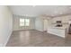 Open-concept living room with modern flooring, abundant natural light, and a view into the kitchen at 9570 Beckett St, Avon, IN 46123