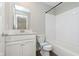 Bathroom with white tile backsplash, a white vanity with a solid surface countertop and shower/tub combo at 9583 Beckett St, Avon, IN 46123