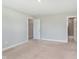 Bright bedroom with neutral walls and carpeting, adjacent to a bathroom at 9583 Beckett St, Avon, IN 46123