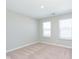 Bright bedroom with neutral carpet, two large windows and neutral paint throughout the room at 9583 Beckett St, Avon, IN 46123