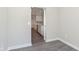 Dining room leading into the kitchen with gray walls and gray wood-look flooring throughout the home at 9583 Beckett St, Avon, IN 46123