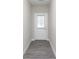 Hallway with gray vinyl floors leading to an exterior door with glass at 9583 Beckett St, Avon, IN 46123