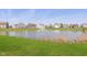Community pond with fountain feature and residential houses in background at 9583 Beckett St, Avon, IN 46123