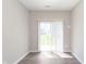 A vacant room with sliding glass doors for outdoor access and neutral walls at 9583 Beckett St, Avon, IN 46123