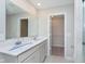This spacious bathroom features double sinks and a door to walk in closet at 9604 Beckett St, Avon, IN 46123