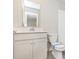 Well-lit bathroom featuring a vanity with storage, toilet, and subway-tiled shower at 9604 Beckett St, Avon, IN 46123