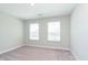 A bright, carpeted bedroom featuring two windows providing natural light at 9604 Beckett St, Avon, IN 46123
