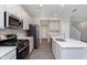 Modern kitchen featuring an island, white countertops, and stainless steel appliances at 9604 Beckett St, Avon, IN 46123