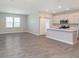 Spacious living room featuring grey wood floors and natural light at 9604 Beckett St, Avon, IN 46123