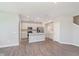 Spacious living room with modern floors adjacent to the open kitchen at 9604 Beckett St, Avon, IN 46123