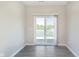 Bright living room with wood floors and sliding glass doors to a patio with a view of the community pond at 9604 Beckett St, Avon, IN 46123