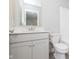 Bathroom vanity with gray cabinets, stone countertop, chrome hardware, and a toilet to the right at 9652 Beckett St, Avon, IN 46123
