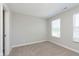 Neutral bedroom showcasing two windows allowing natural light, carpeted floors, and neutral walls at 9652 Beckett St, Avon, IN 46123
