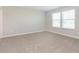 Bright bedroom featuring neutral carpet, base trim and dual windows providing lots of natural light at 9652 Beckett St, Avon, IN 46123
