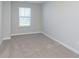 Empty bedroom with carpeted floors, neutral walls, white trim, and a bright window at 9652 Beckett St, Avon, IN 46123