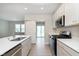 Modern kitchen featuring an island, stainless steel appliances, and a sliding barn door at 9652 Beckett St, Avon, IN 46123